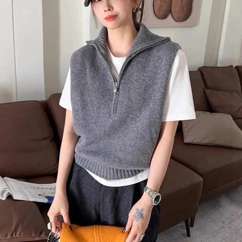 Women's half-zip sleeveless knit vest in mesh fabric with a 3D pattern, shown in orange colour.