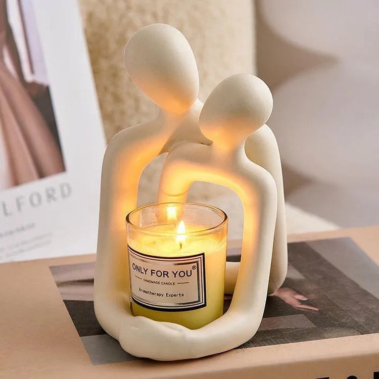 Modern couple resin statue in milky white or gold colour on a desk or shelf