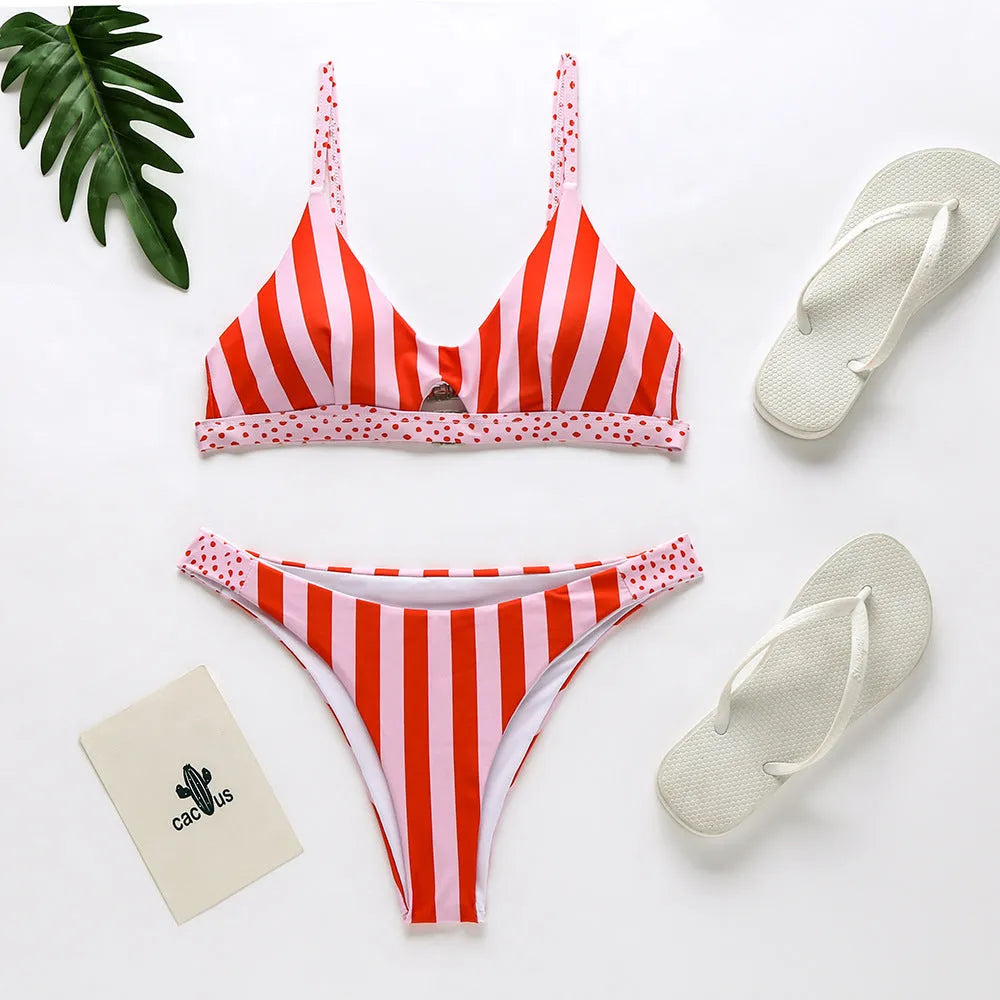 Women's black and white dot and red and white stripe polyester bikini swimsuit set on a mannequin.