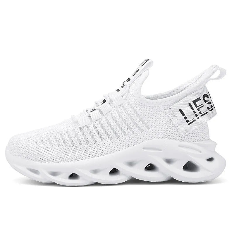 Kids coconut sneakers with Velcro closure in black, khaki, or white colours showing fabric upper and EVA sole