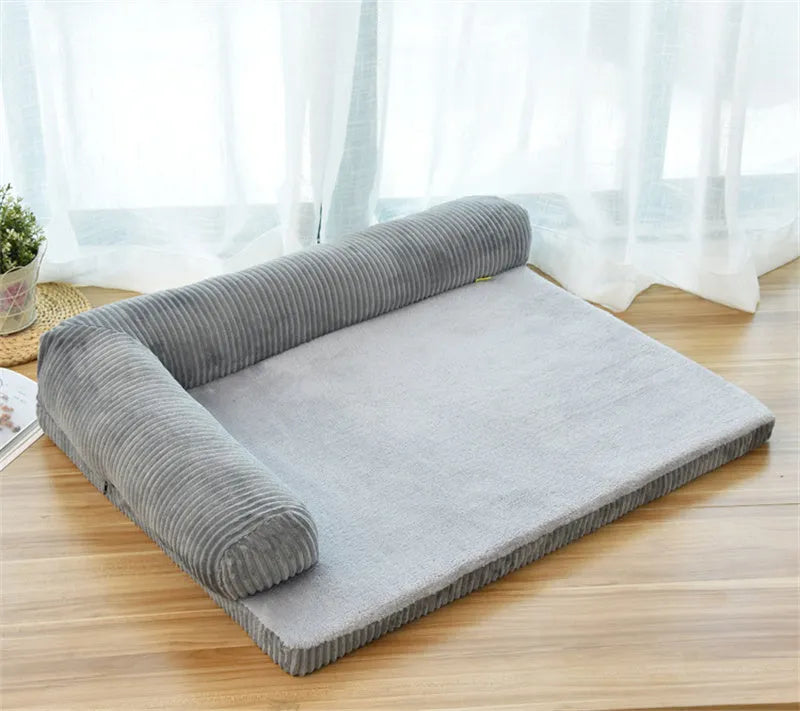 Corduroy dog sofa bed with raised sides in grey colour, showing non-slip base and cushioning.