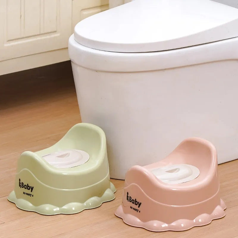 Children's small portable thickened toilet in Green with lid on white background
