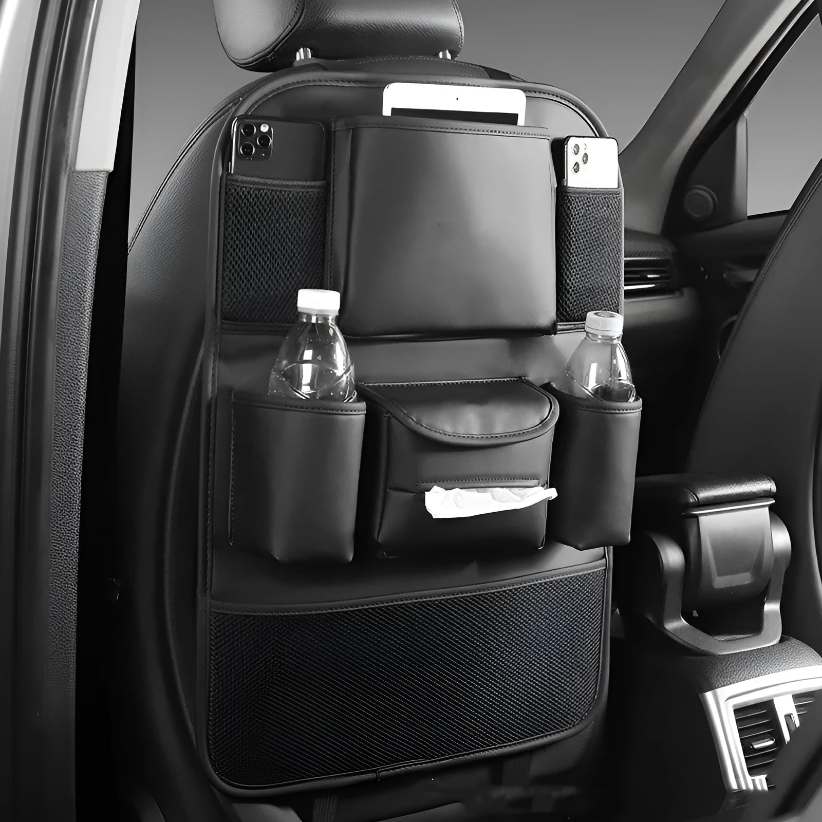 Black leather car seat back storage bag hanging from a headrest