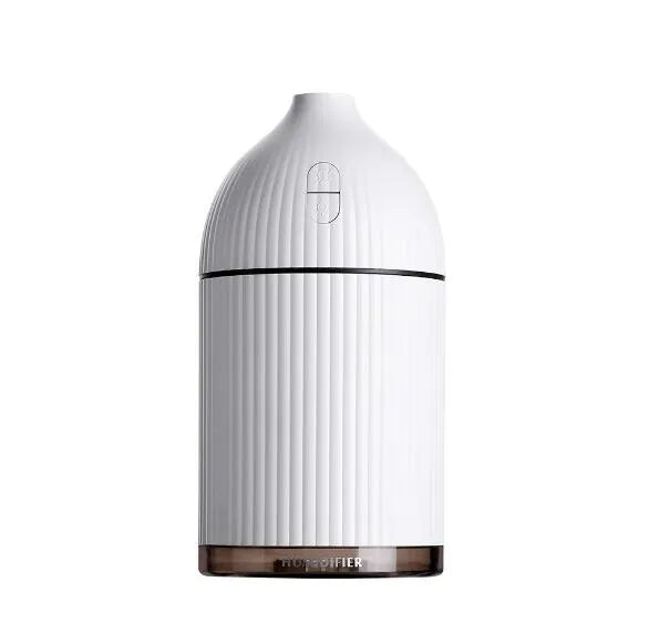 White ultrasonic aromatherapy diffuser and humidifier with 300ml capacity, USB port, and LED light on a wooden surface.