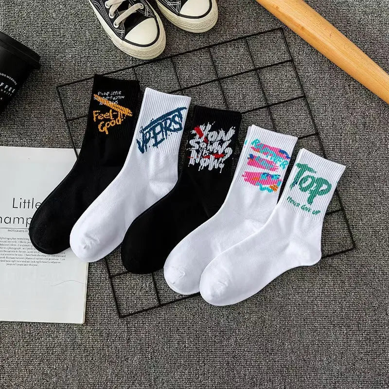 10 pairs of white cotton tube socks with graffiti pattern, middle calf length, on a plain background