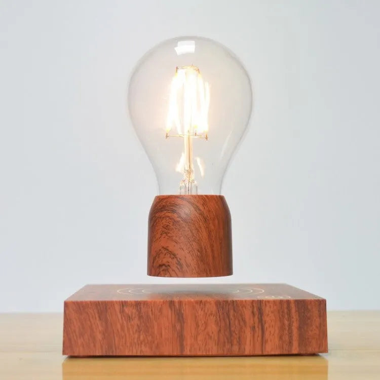 Magnetic levitation light bulb with imitation wood base on table.