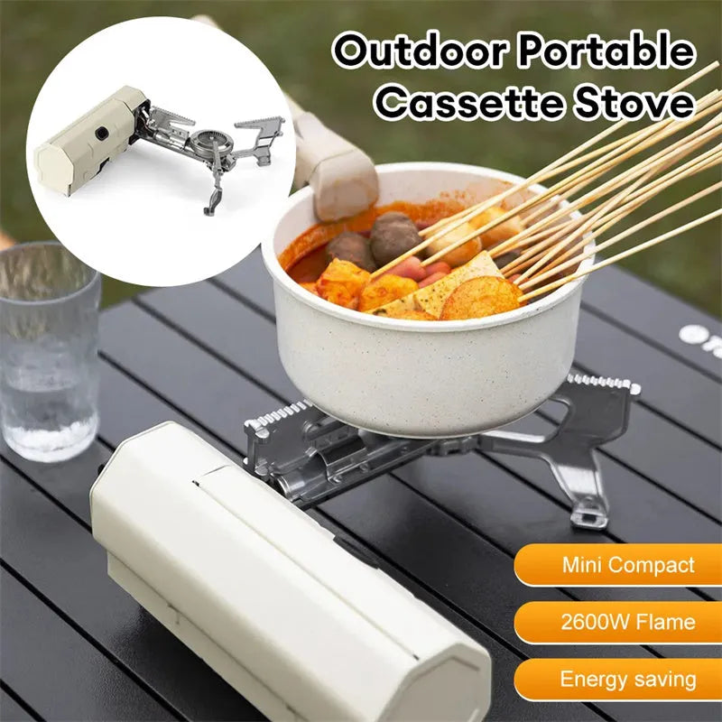 Green portable folding gas stove with serrated pot support and adjustable valve, shown with storage bag.