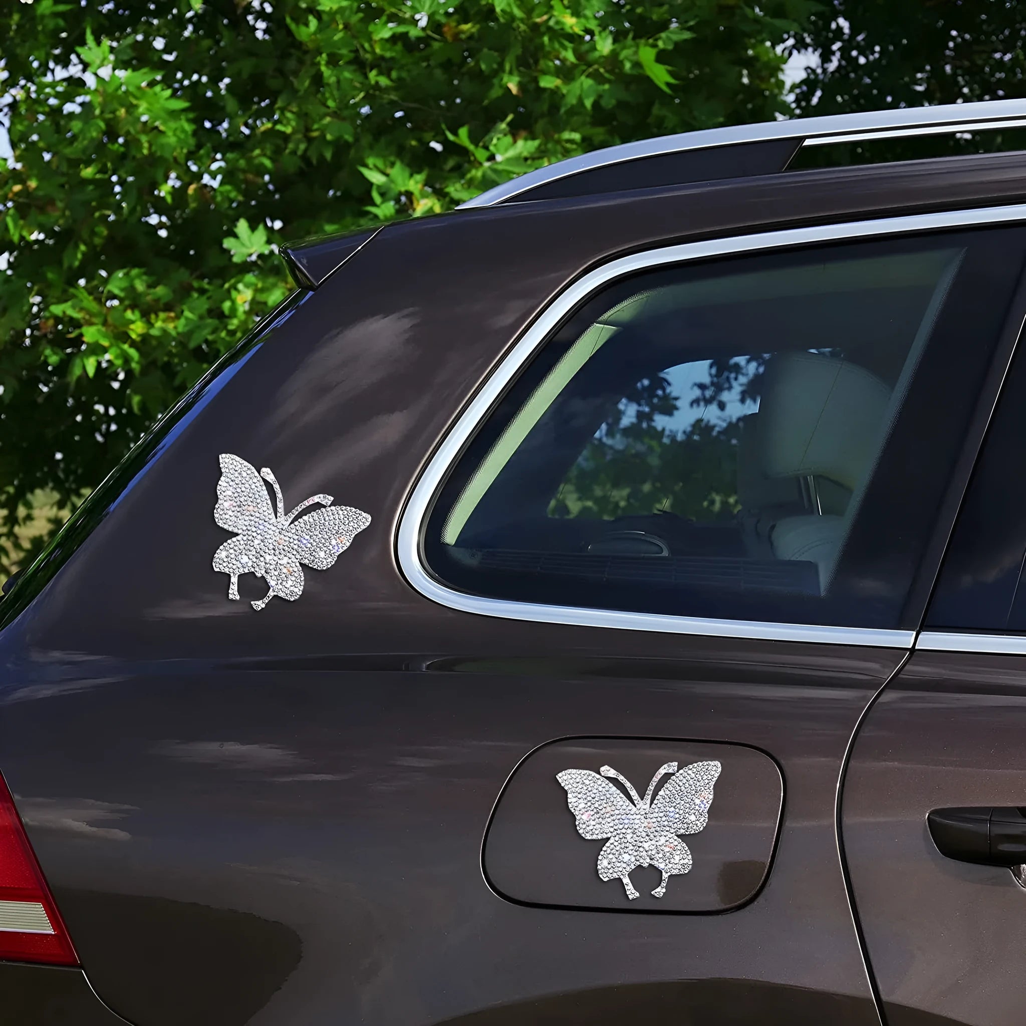White diamond butterfly and bear claw design glass car sticker measuring 7 by 6 centimetres.