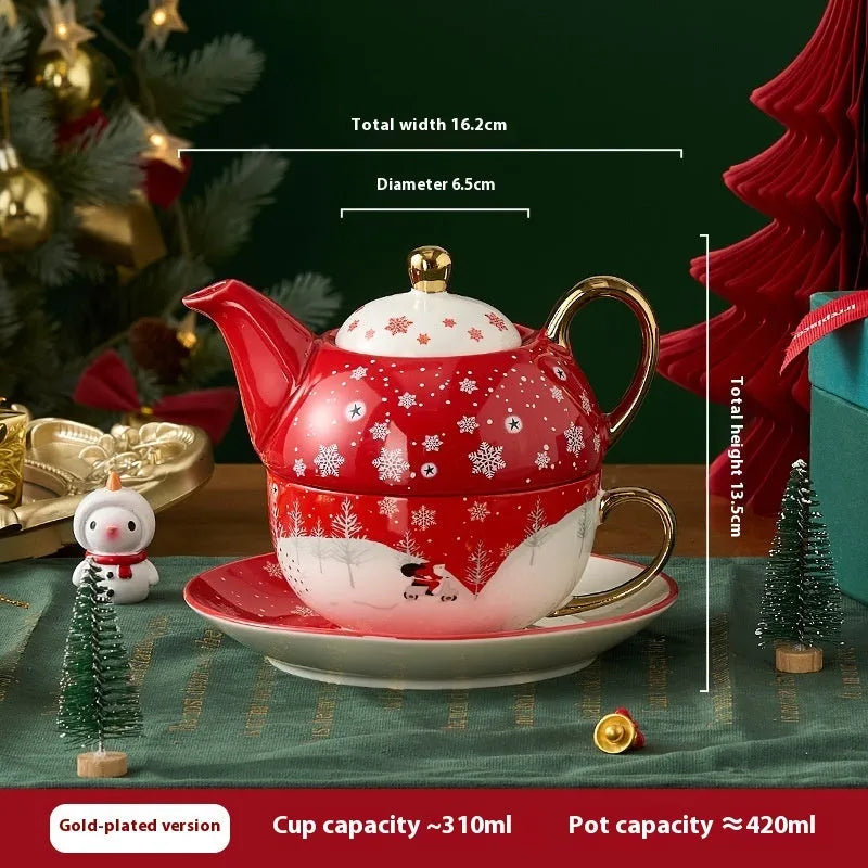 Ceramic gold-plated Christmas teapot set with snowflake design, including pot on dish and cup on dish with spoon, in gift box.