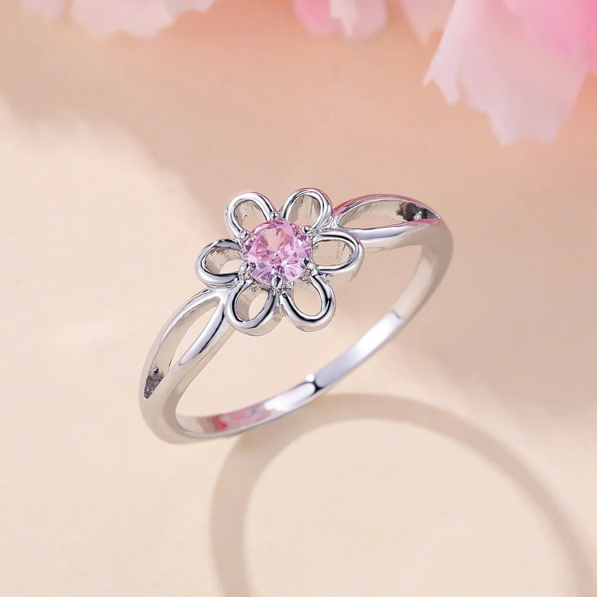 Women's hollow floral ring made from copper with electroplated finish in platinum pink diamond colour