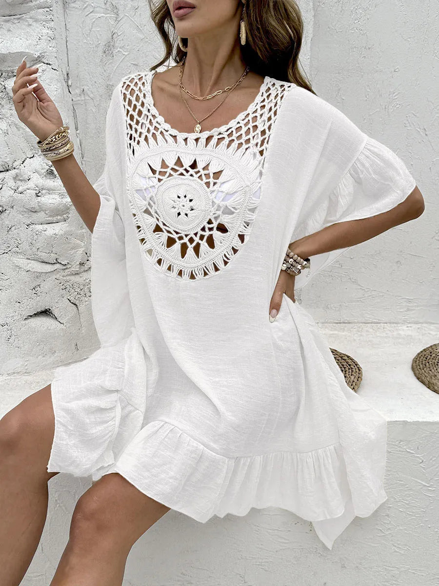Crochet stitch patchwork beach cover-up dress in apricot colour, showing tassel details and textured fabric.