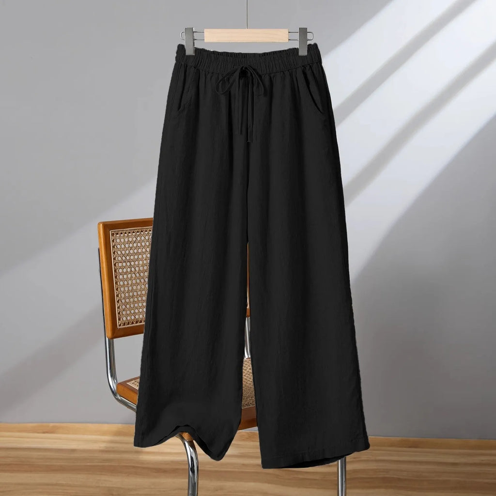 Women's straight leg casual trousers in khaki with an elastic waistband and lace-up drawstring detail.