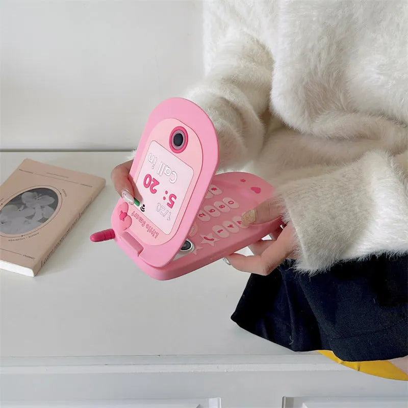 Light pink silicone flip phone shape mirror case for iPhone showing built-in mirror and nostalgic design