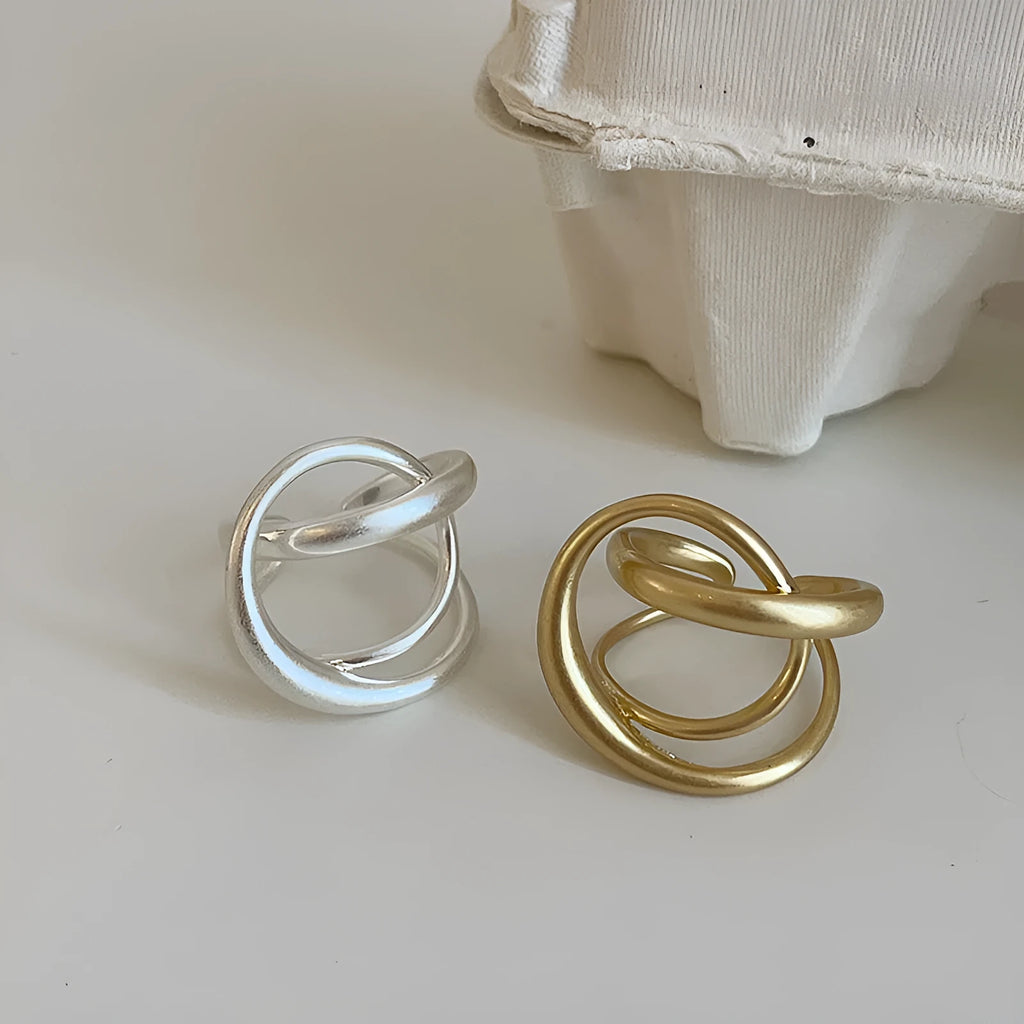 Three-dimensional interlaced geometric open ring in matte metal with gold plating