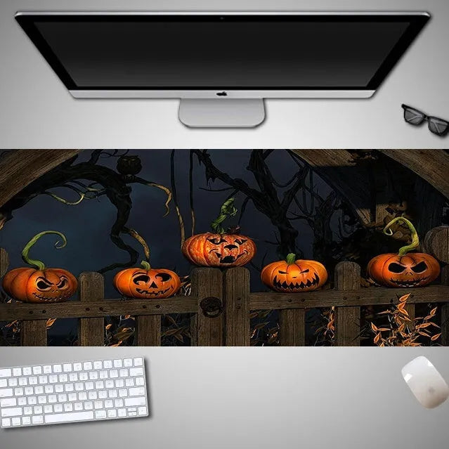 Oversized Halloween-themed gaming mouse pad with non-slip base on a desk.
