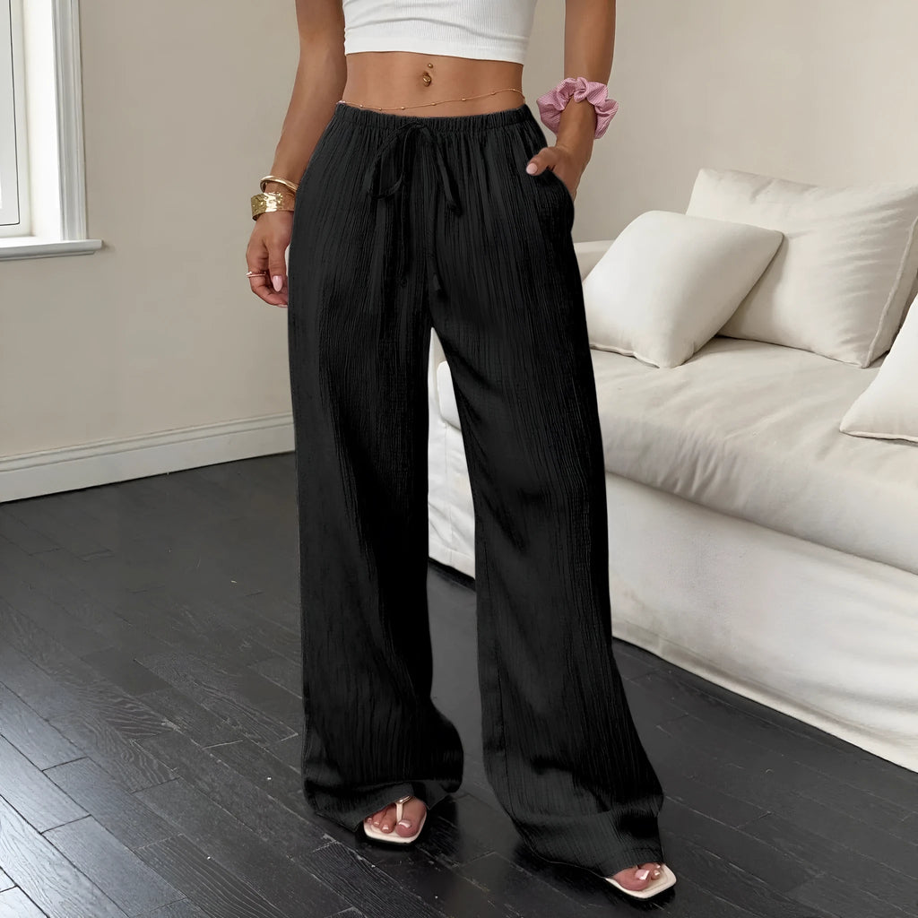 Black wide leg women's trousers with a lace-up waist trimming detail on a mid waist.