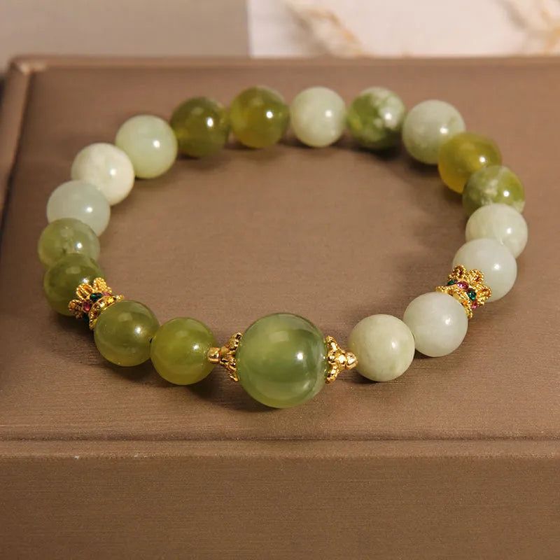 Original design women's bracelet made from green Xiuyan jade in a sweet mori style.