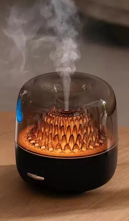 Round resin aroma diffuser with colourful light in beige, on a desktop, with a single fog nozzle