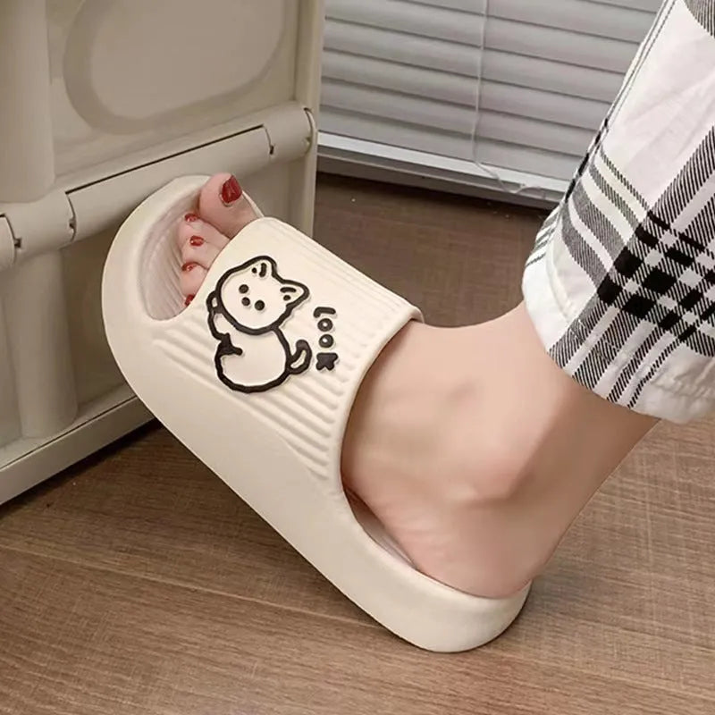 Women's green cat slippers with thick EVA platform sole on a wooden floor