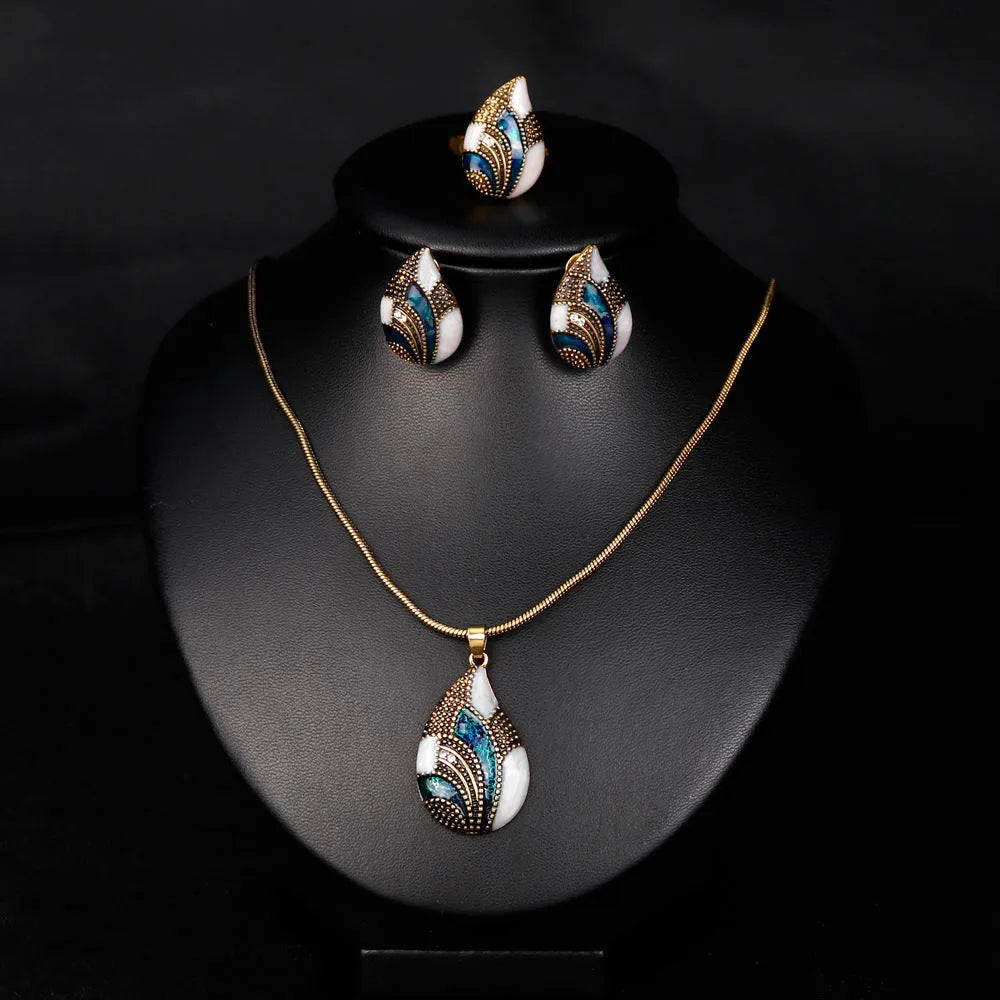 Water drop jewelry set including necklace, earrings and ring in gold or silver zinc alloy finish.
