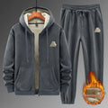 Man wearing a grey hooded cashmere sweater and matching cotton trousers from a casual sports suit.