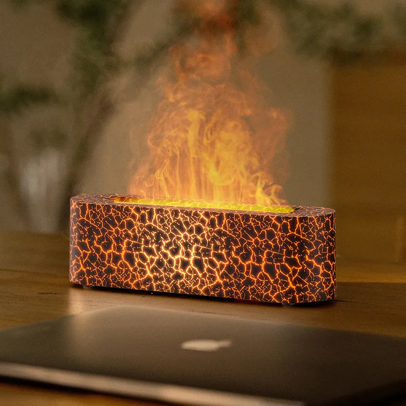 Square-shaped lava lamp-style USB aroma diffuser humidifier with colourful flame light effect on a desk.