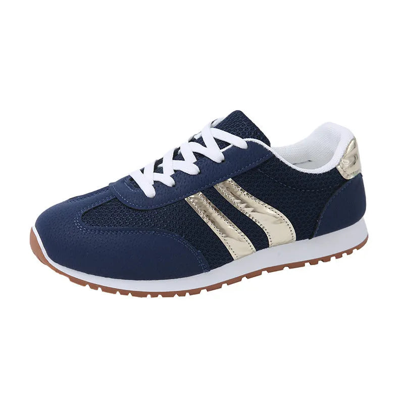 Blue women's casual tennis shoes with cross shoulder straps and a flat rubber sole