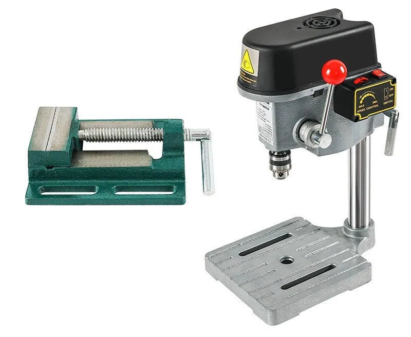 Bench drill milling machine on a workbench with cross bench pliers.