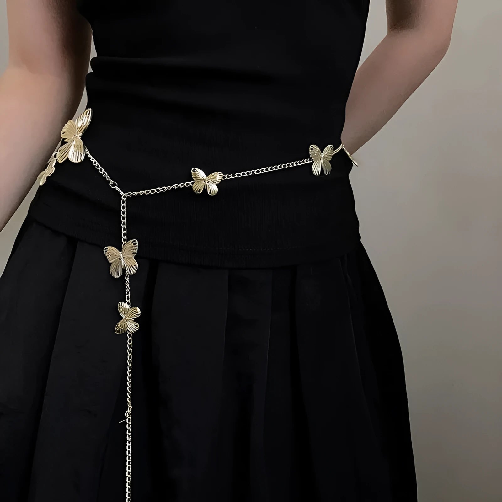 Gold or silver alloy butterfly waist chain measuring 104cm in length.