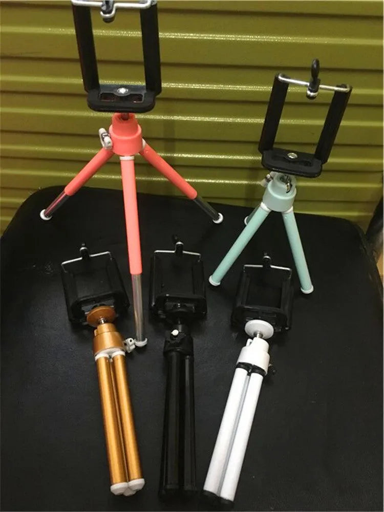 Two-section adjustable desktop phone holder in black and silver colour options on a desk