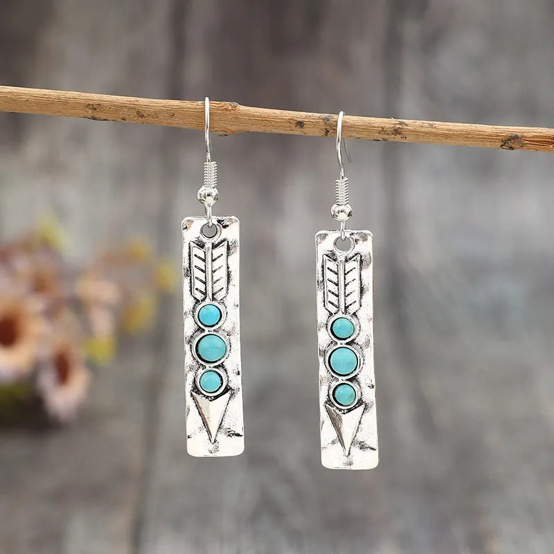 Women's silver geometric earrings with turquoise inlay detailing on long strip alloy design