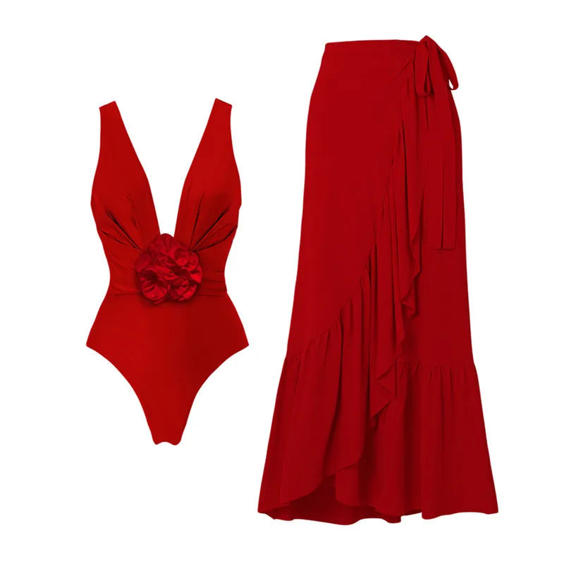 Red women's V-neck one-piece swimsuit with open back and detachable flower, shown with matching skirt.