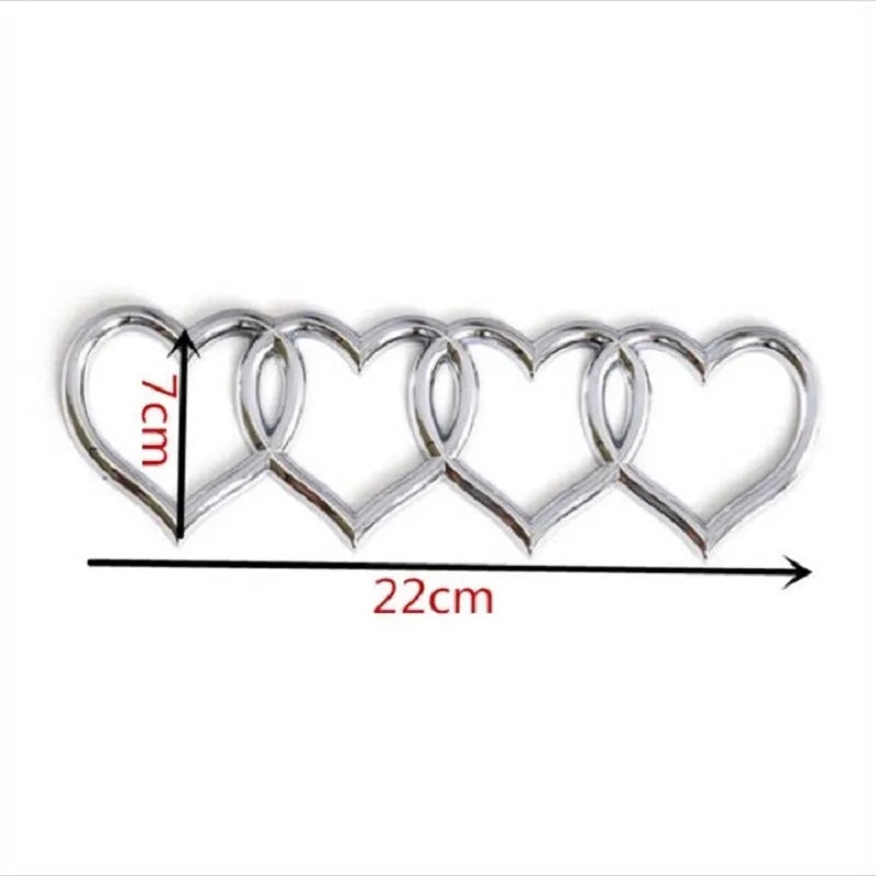 Heart-shaped body sticker with four-ring tail design in electroplated silver colour on a car bumper