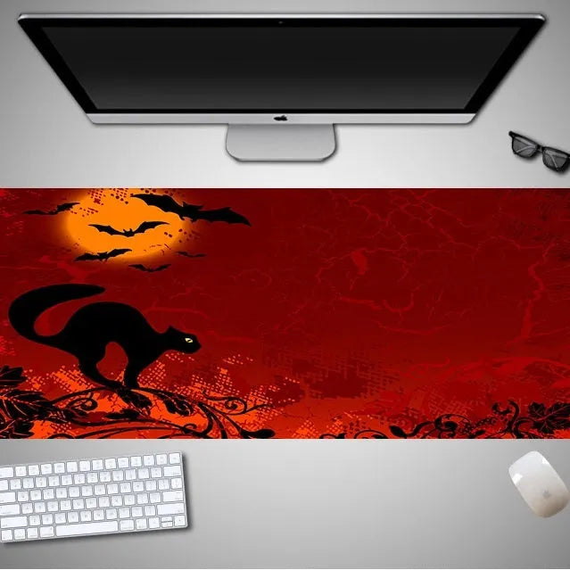 Oversized Halloween-themed gaming mouse pad with non-slip base on a desk.