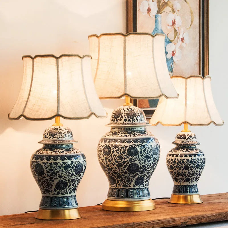 Chinese blue and white porcelain table lamp with cloth shade on wooden surface