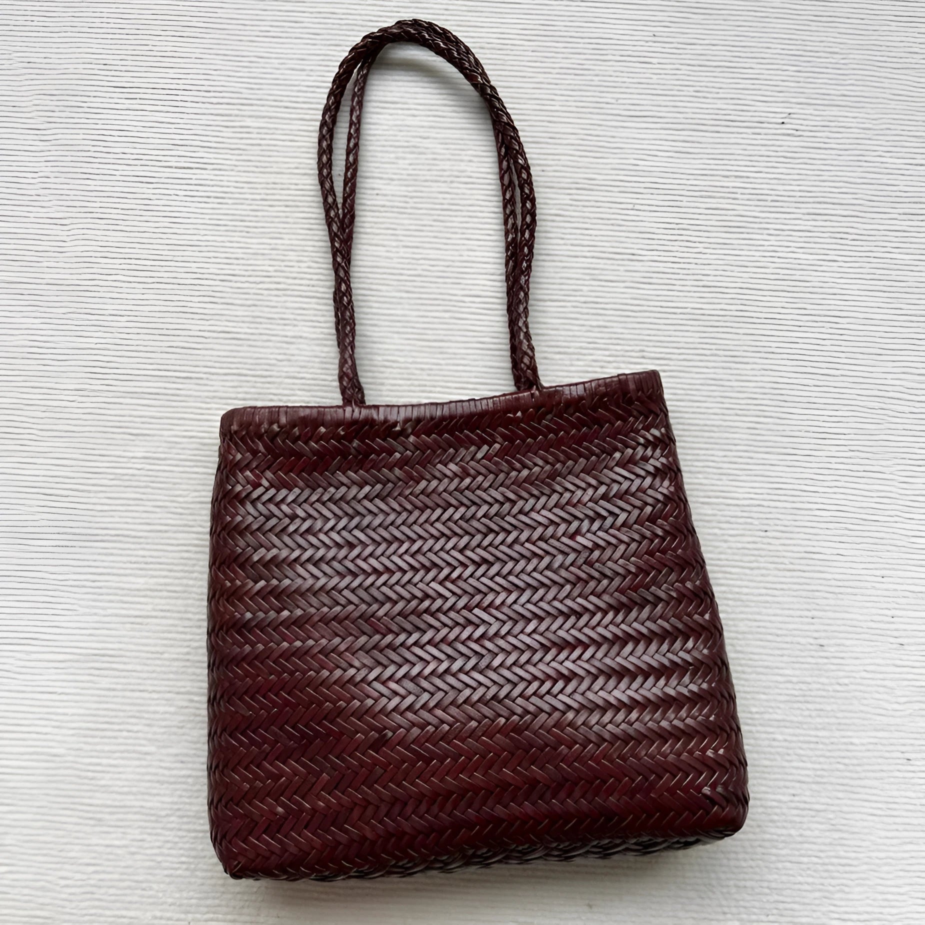 Handmade brown woven leather tote bag with three-dimensional pocket and shoulder strap