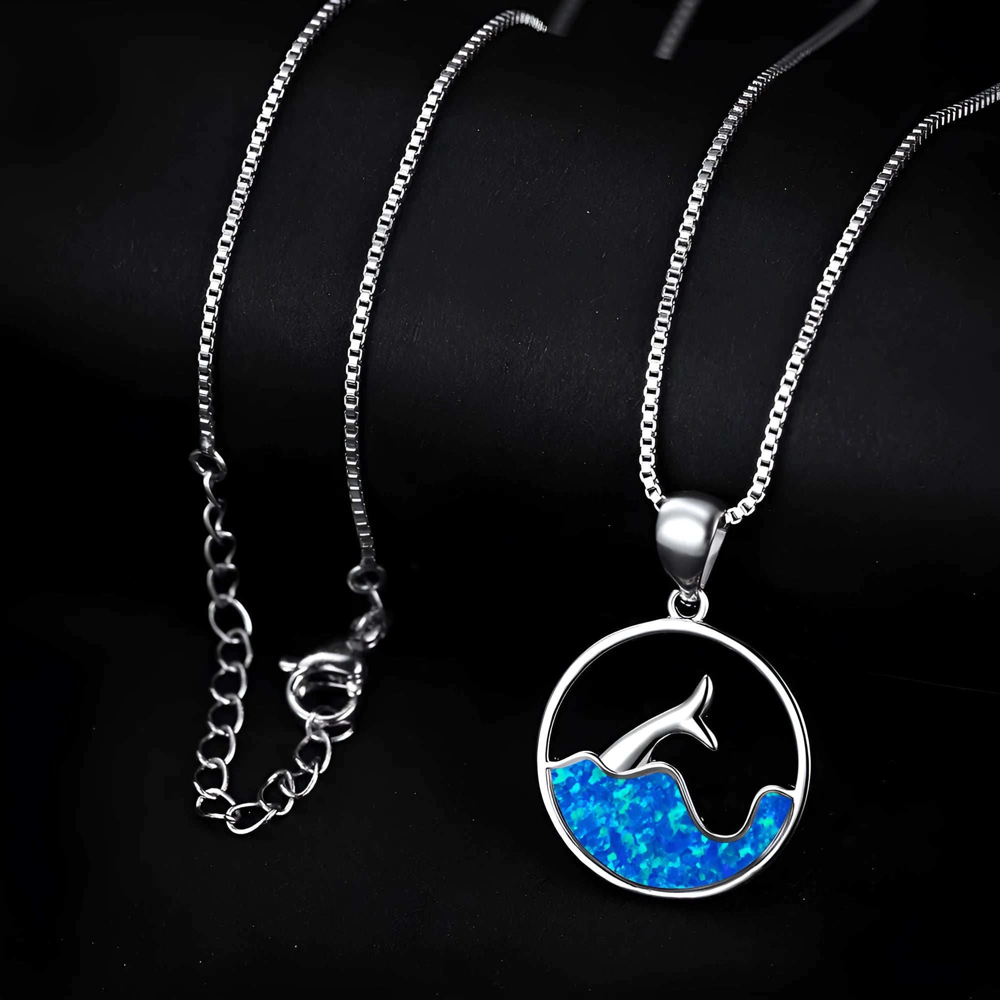 White gold electroplated copper necklace with geometric sea fishtail pendant in blue opal colour.