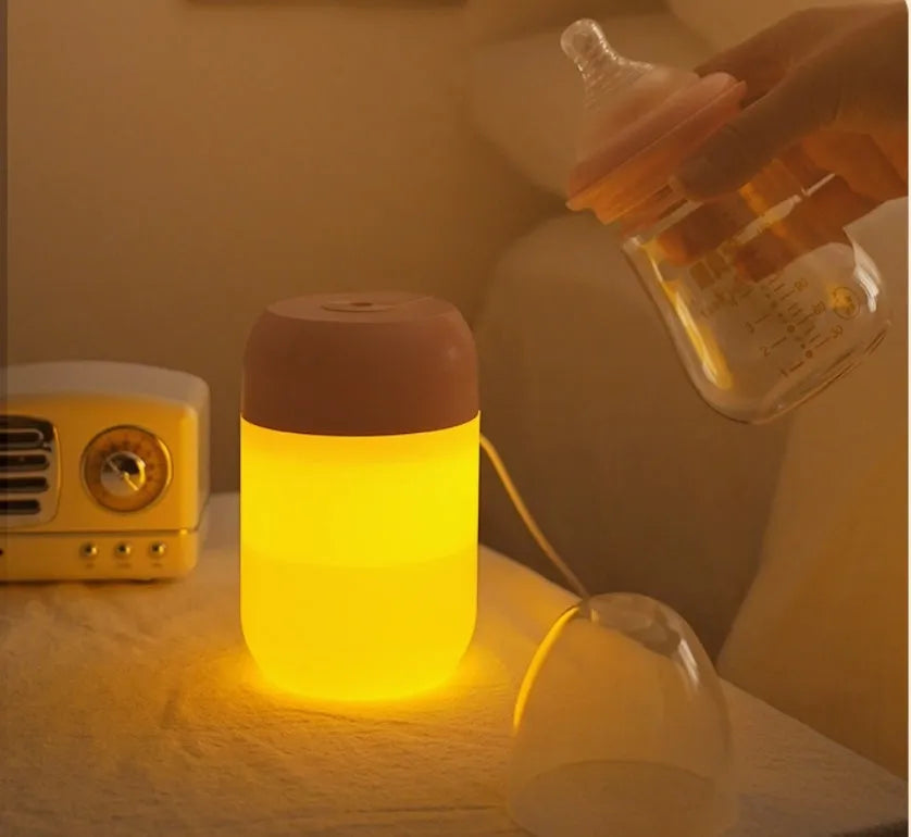 White cylindrical USB-powered small humidifier with aromatherapy function on wooden desk