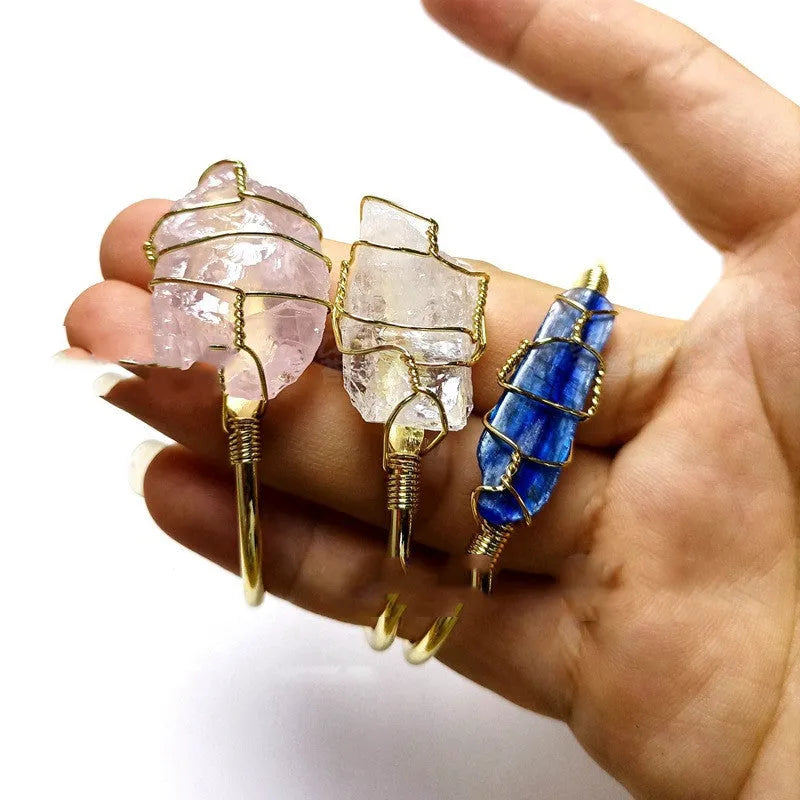 Explosive design natural crystal rough stone bracelet with gold winding on a wrist.