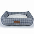 Square grey and brown plaid cloth dog bed for winter, shown in small and large sizes.
