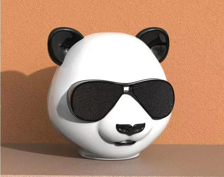 A portable classic style mini Bluetooth speaker on a table, showing its compact design.