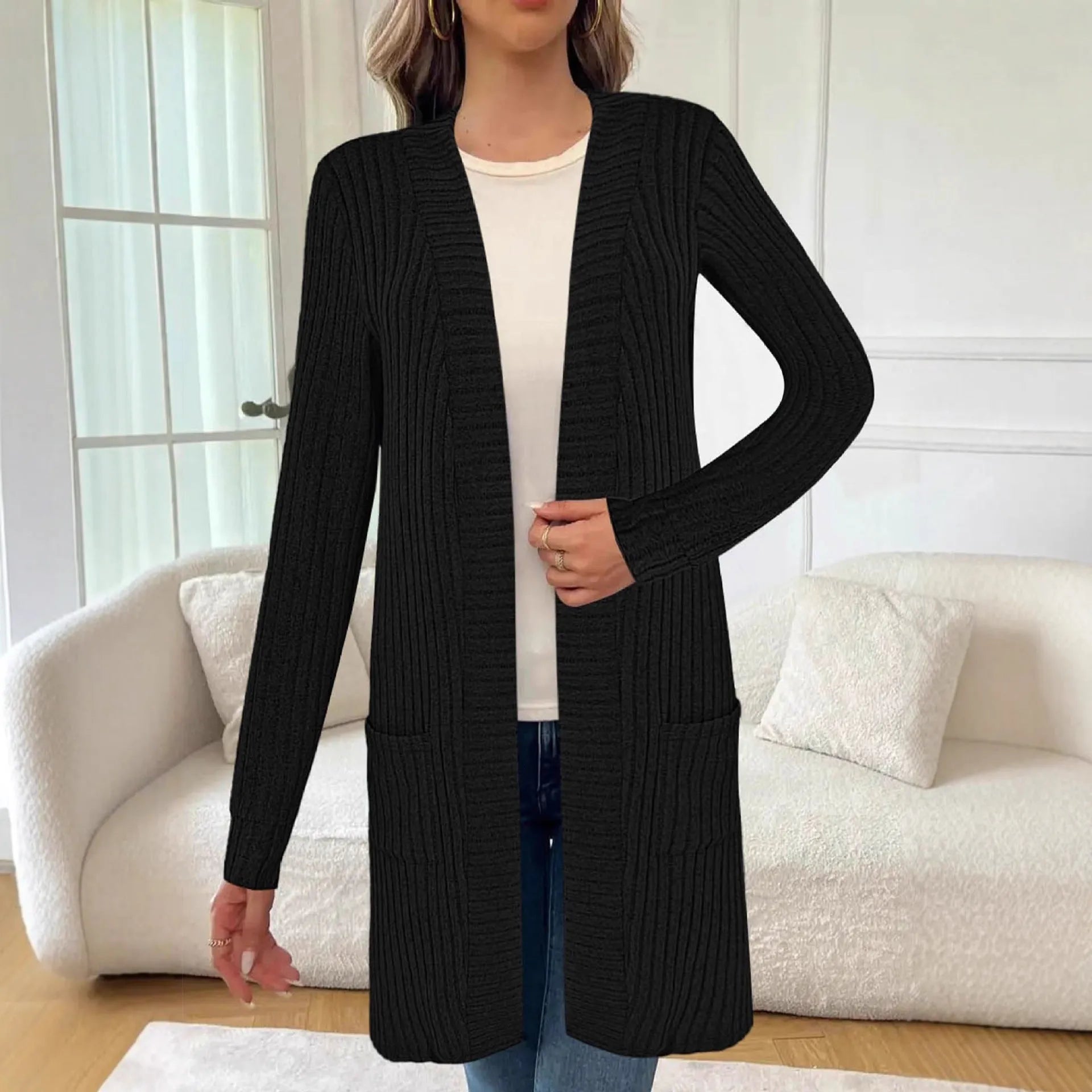 Loose long sleeve knitted cardigan jacket in black with side pockets.