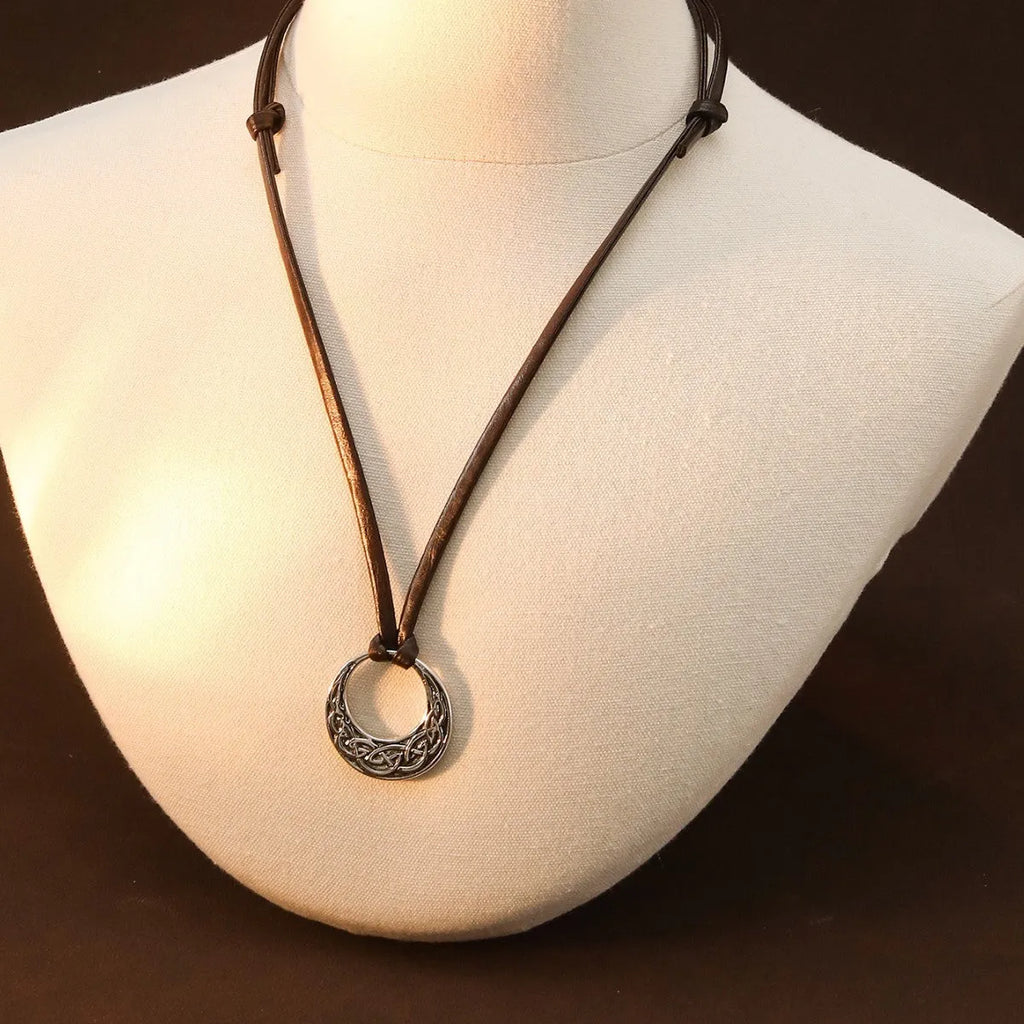 Alloy skull pendant necklace with adjustable knot chain in antique silver on a neutral background