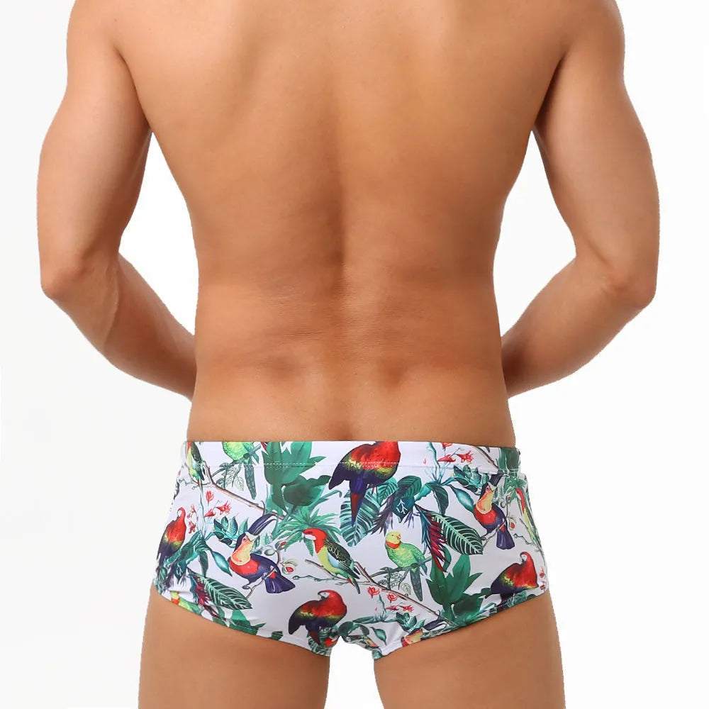 Men's floral bird print swimming trunks in nylon fabric, shown in small boxer style.