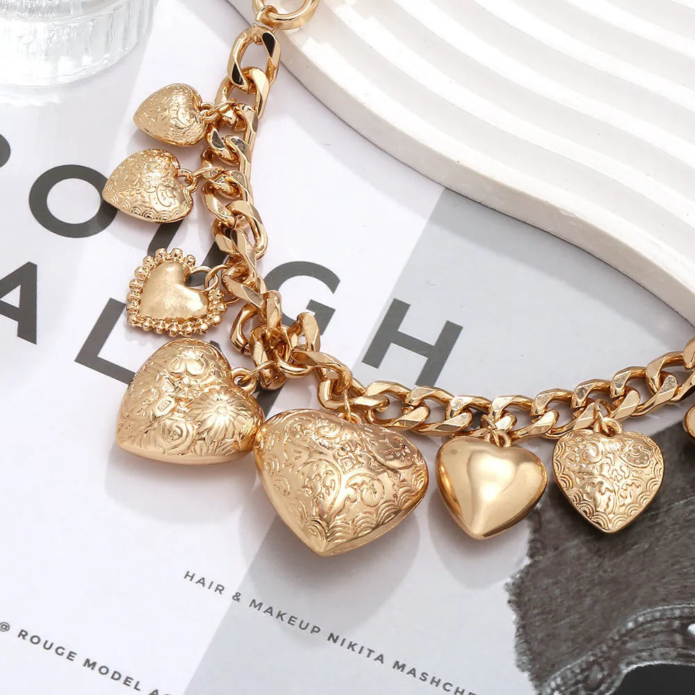 Gold carved heart pendant necklace on adjustable metal chain with exaggerated heart shape