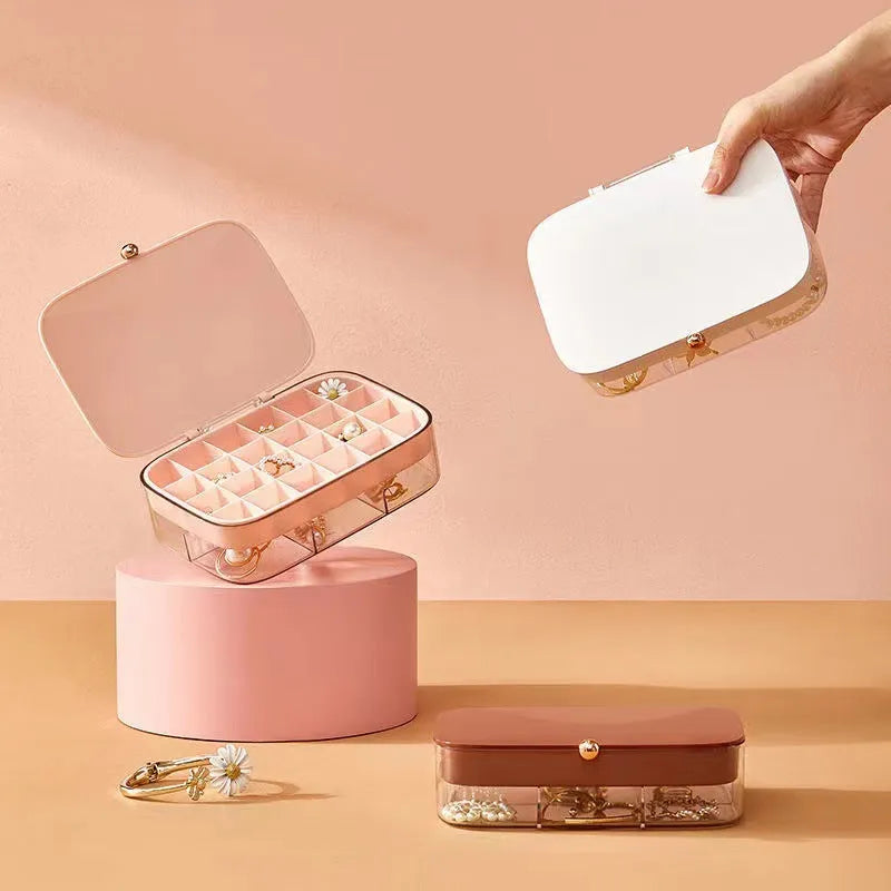 Modern minimalist green jewellery storage box with multi-layer compartments open on a dressing table.
