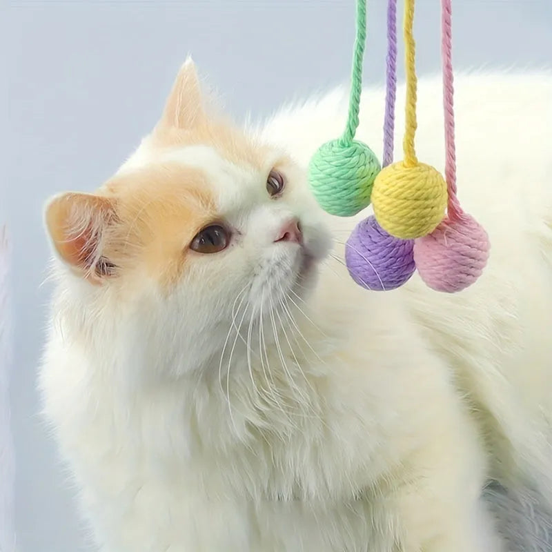 Cat toy ball with attached rope and bell in green, pink, purple or yellow colours showing 6cm and 3cm size comparison