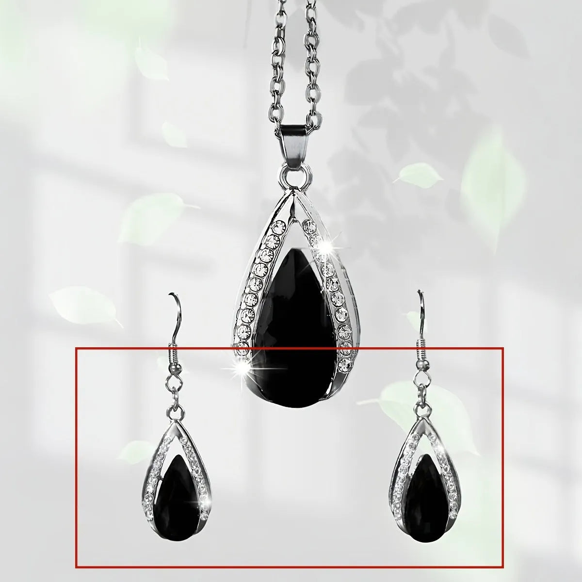 Black and red alloy water droplet pendant necklace and matching earrings jewellery suite.