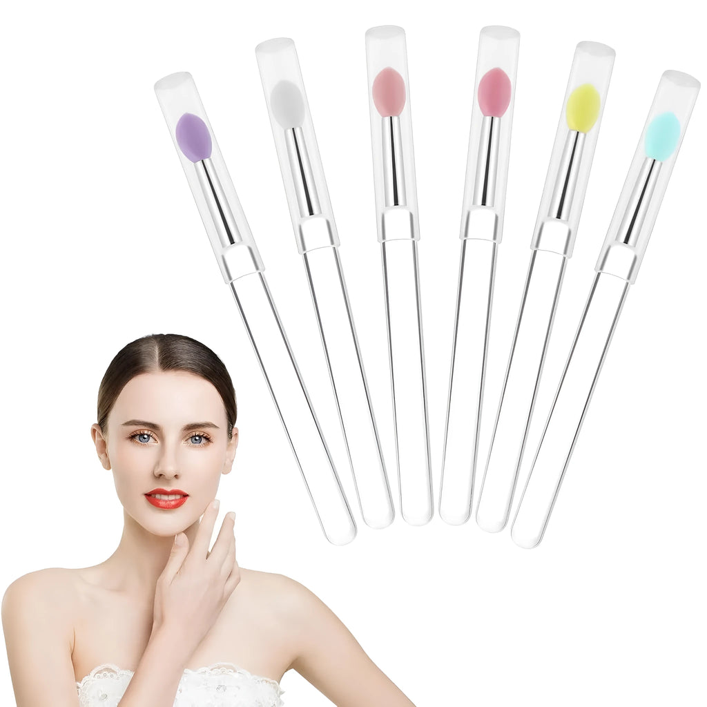 Set of eight coloured reusable silicone lip brushes with protective caps on a white background.