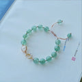 Handcrafted strawberry quartz crystal bracelet with green strawberry quartz moon charm for women